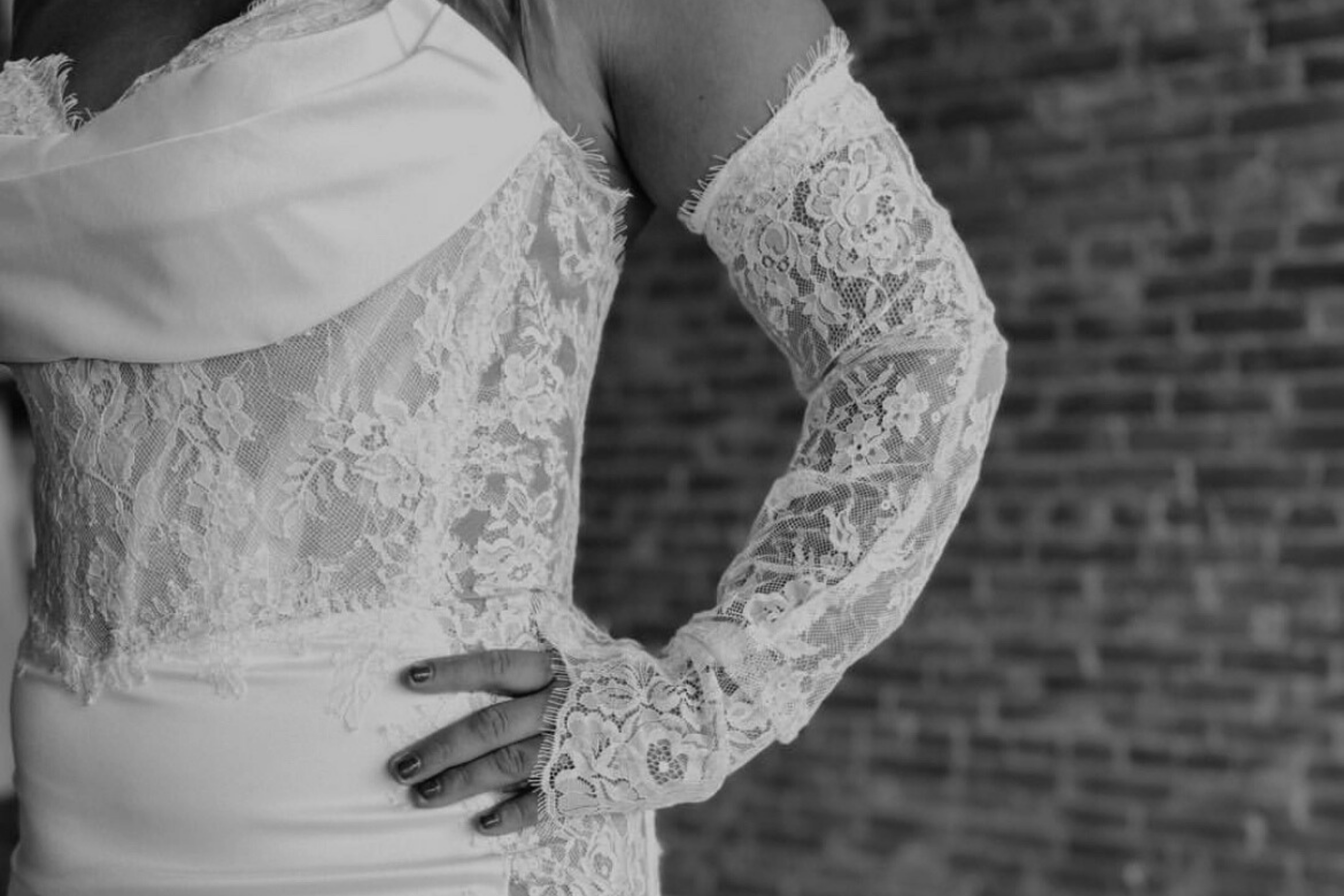 black and white close up of the lace detailing on a dress