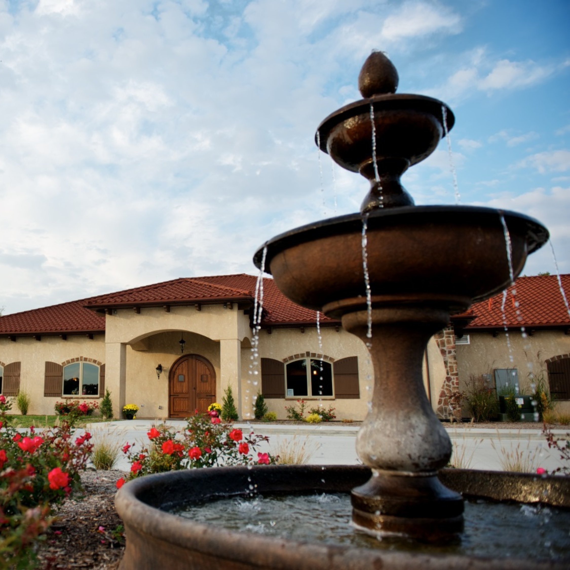 outside shot of tuscan hills winery with a focus on their water fountain feature out front