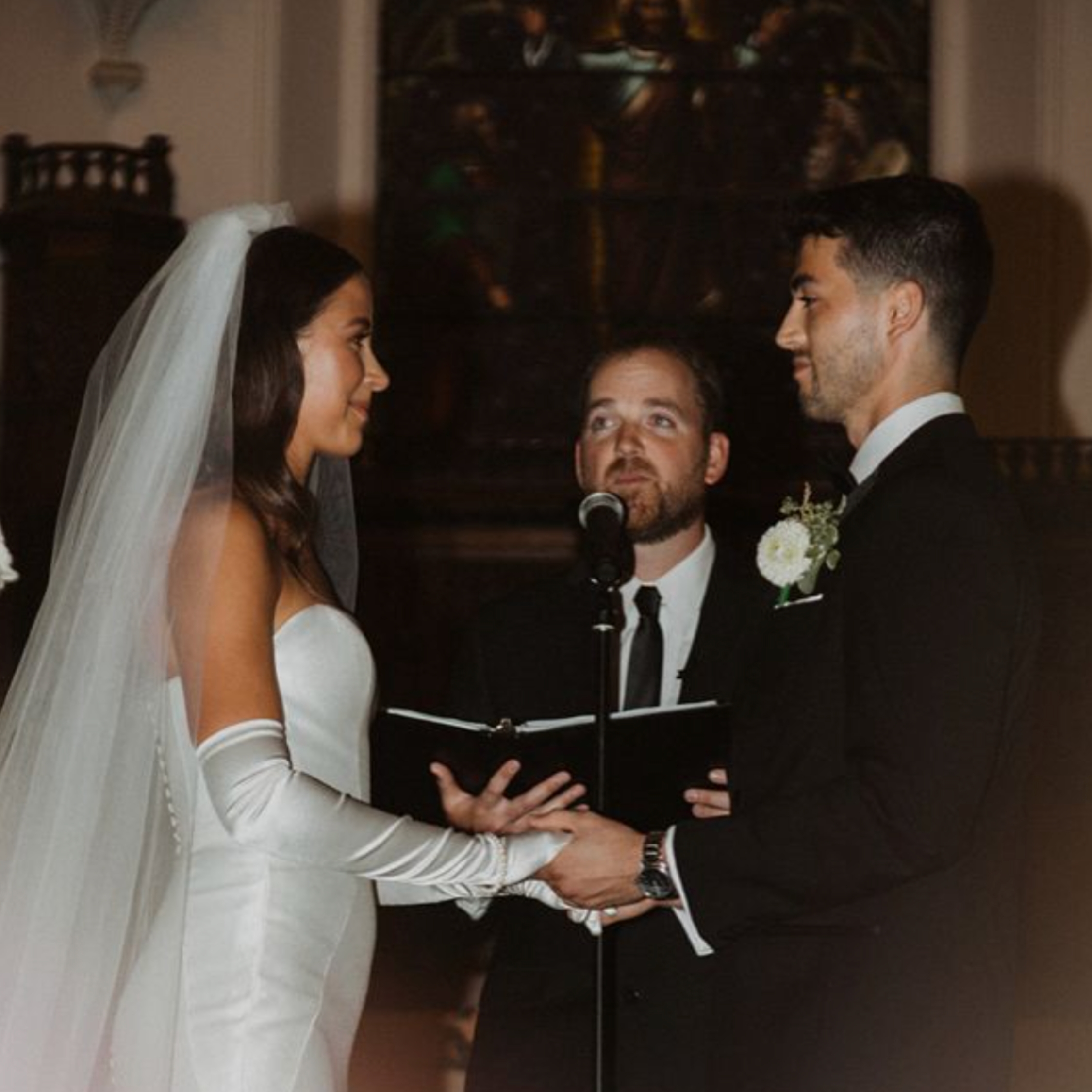bride and groom at the altar with officiant in the background