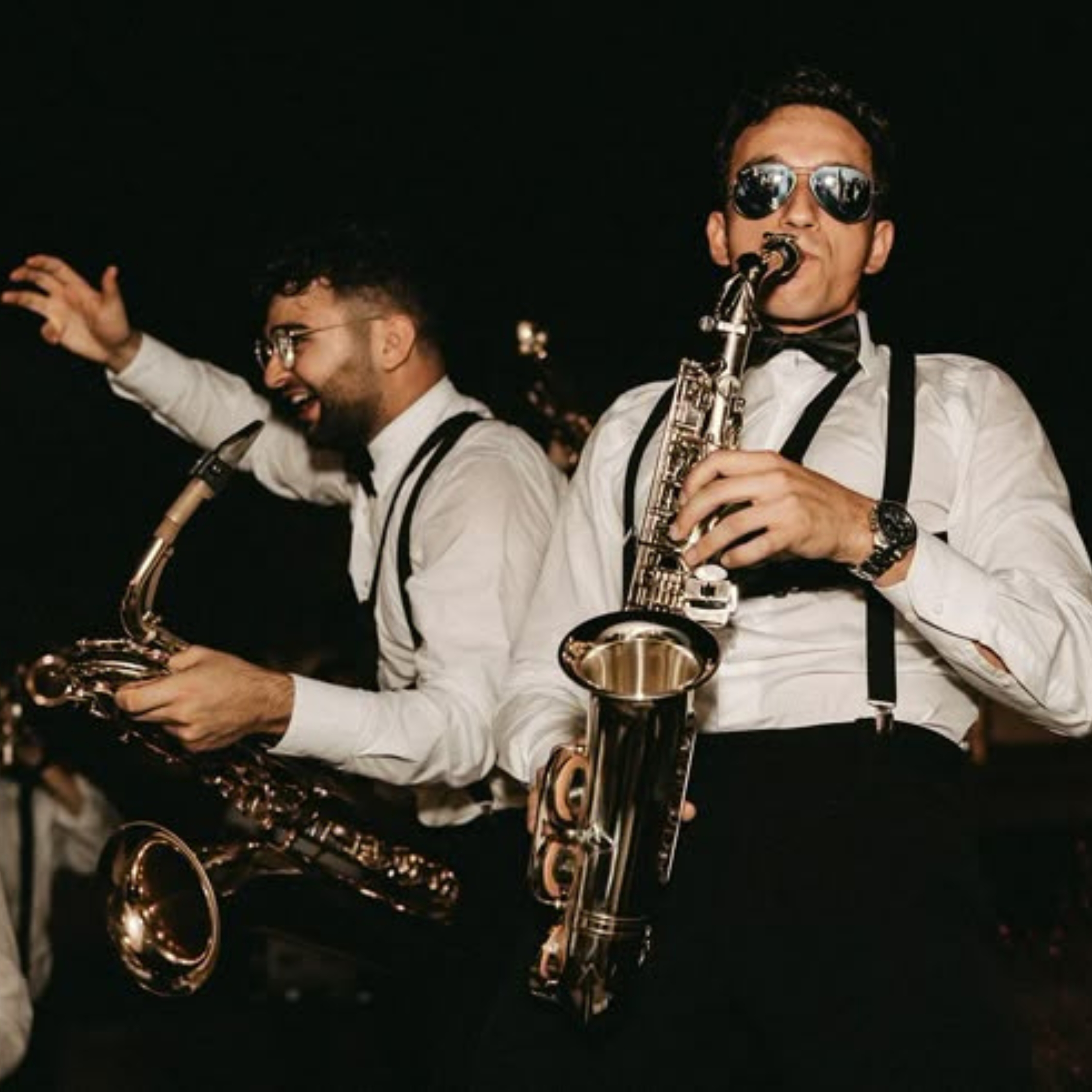 men playing saxophones at a wedding