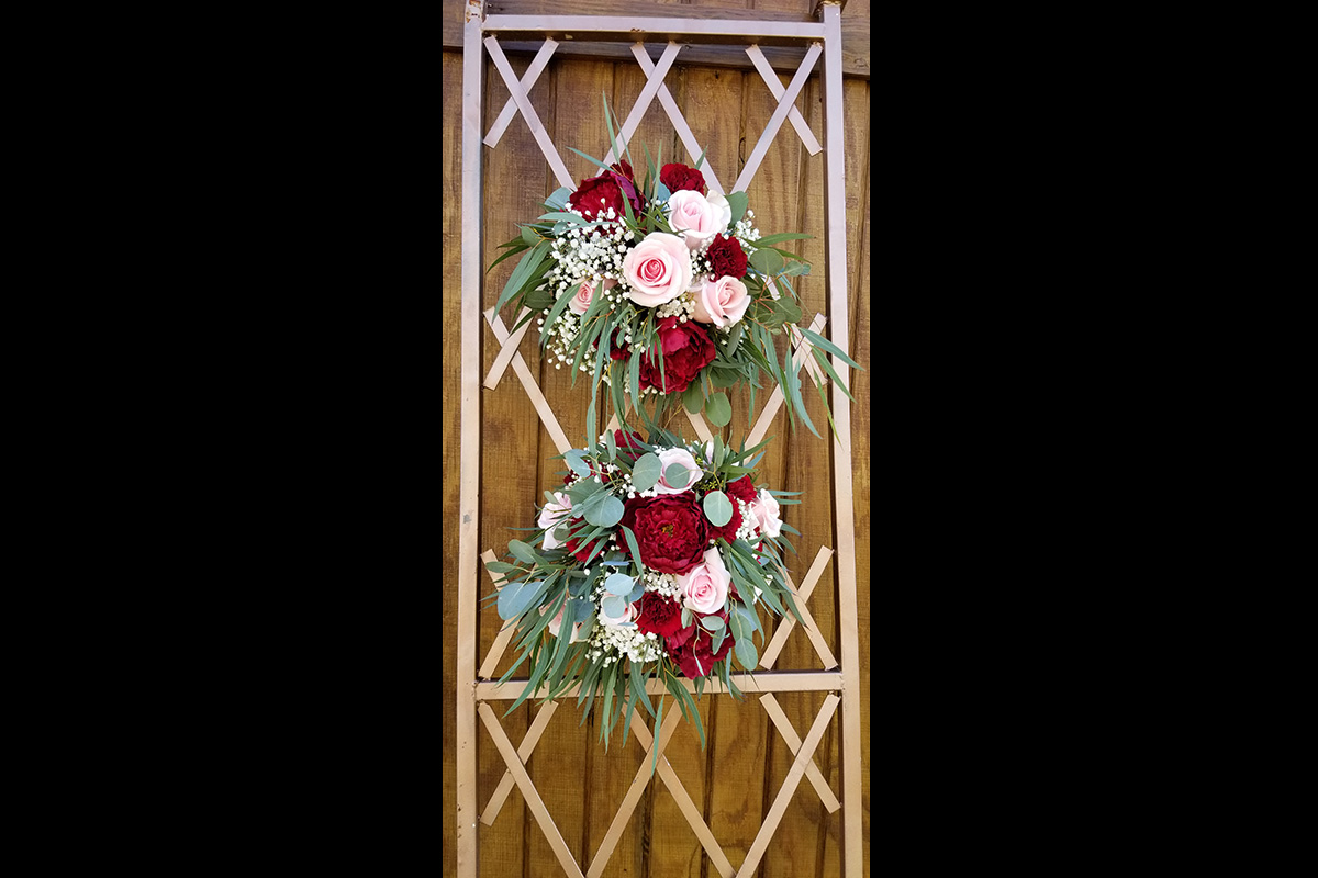 a floral arrangement on a lattice background