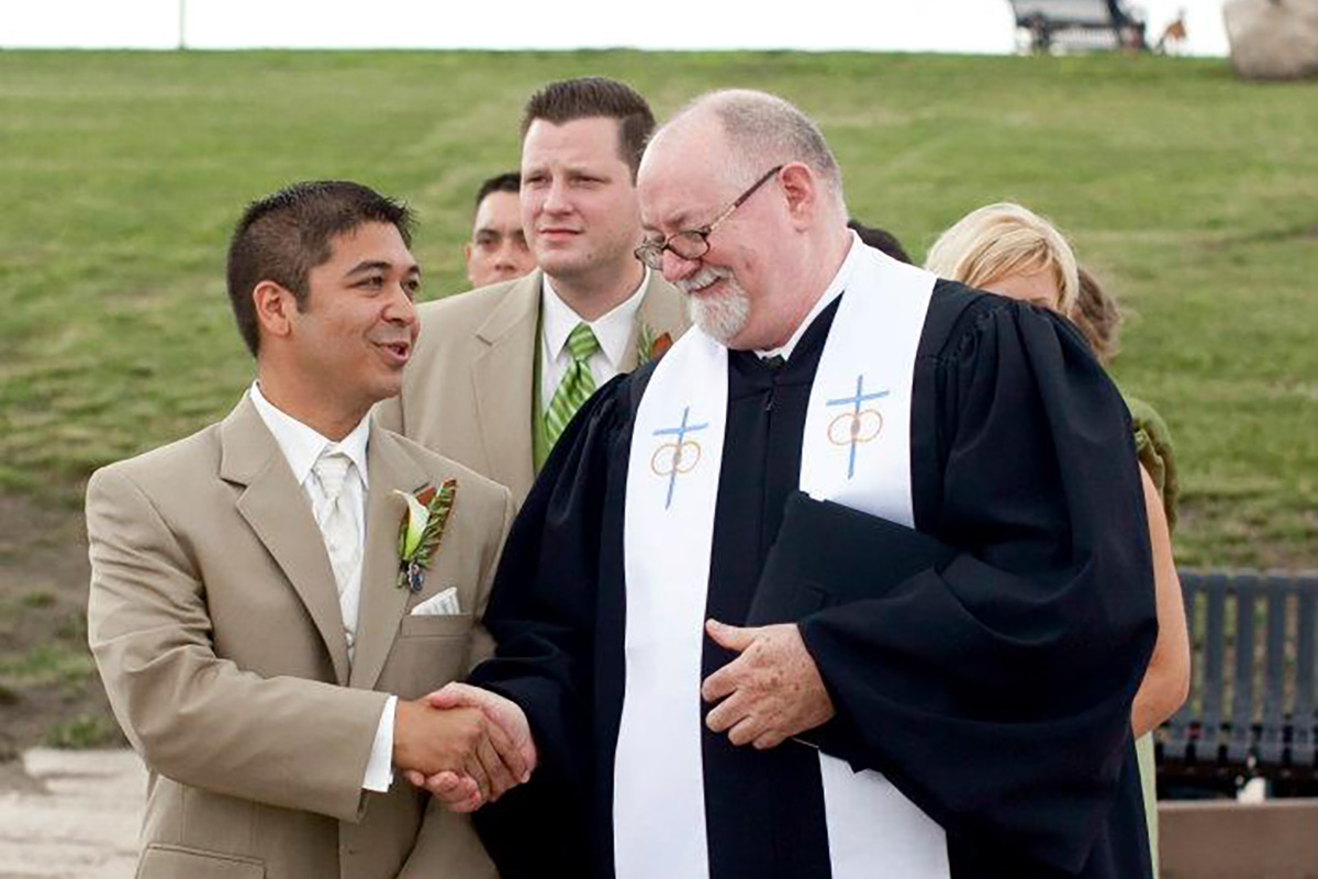 The Marrying Rev shaking hands with a groom