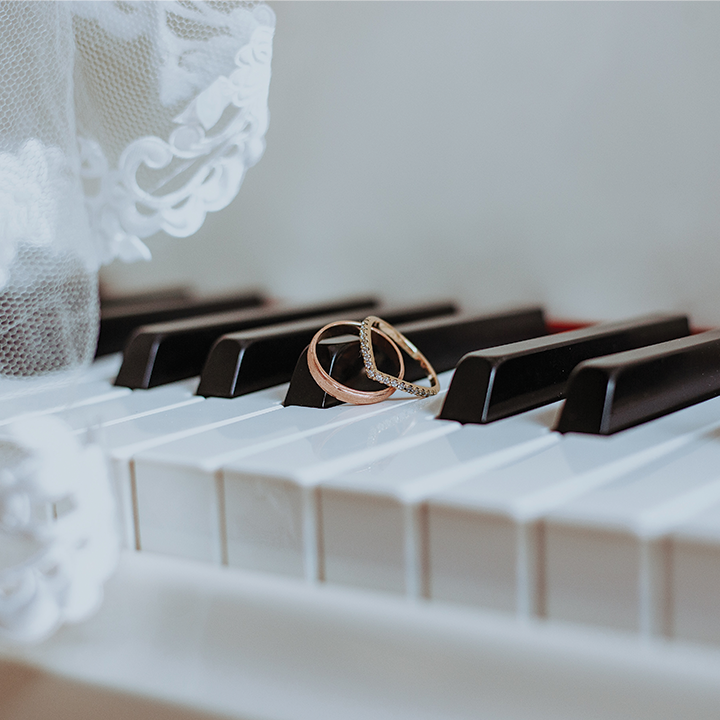 wedding rings on a piano