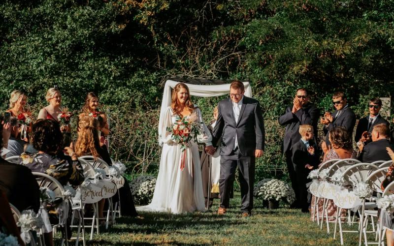 the bride and groom walking back down the aisle after being married at tuscan hills winery
