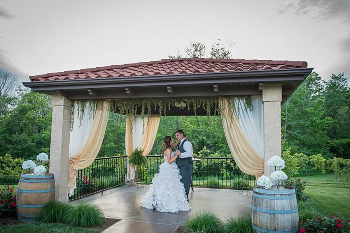 bride and groom dancing under the pergola at Tuscan Hills Winery